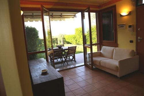 a living room with a couch and a table at GardaGulf EdenGarden in Garda