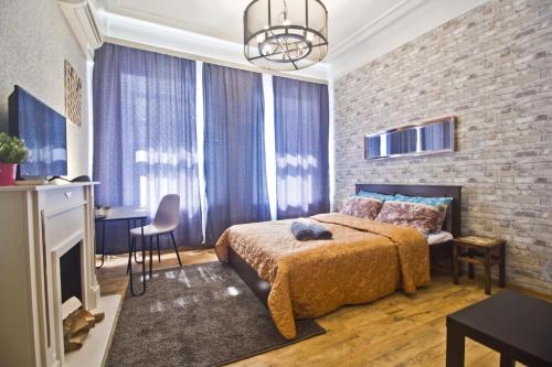 a bedroom with a bed and a brick wall at LAFLATS Volkhonka in Moscow