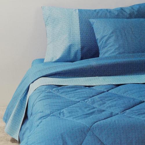 a bed with blue sheets and pillows on it at CASA CARGIA' HOLIDAYS in San Terenzo