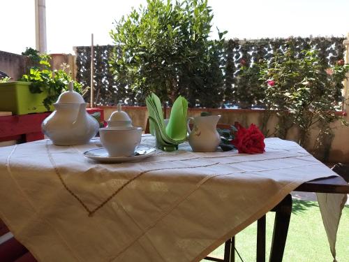 a table with vases sitting on top of it at B&B SA SPIGA in Marrùbiu