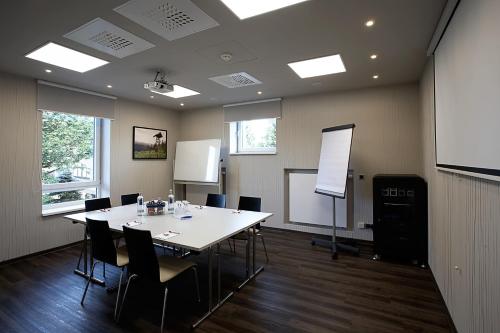 a conference room with a white table and chairs at Konsum Berghotel Oberhof in Oberhof