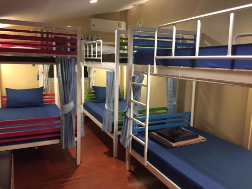 grupa łóżek piętrowych w pokoju w obiekcie Anya House w mieście Thongsala
