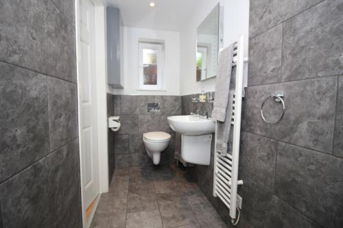 a bathroom with a white sink and a toilet at Beautiful Modern Apartment in Bath in Bath