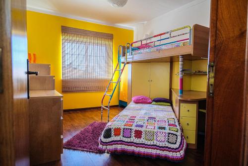 a bedroom with a bunk bed and a ladder at Villa Terra Da Eira in Mafra