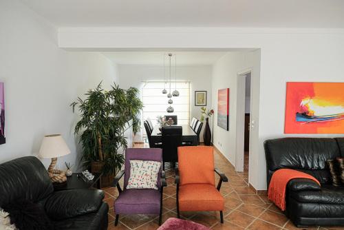 a living room with two chairs and a couch at Villa Terra Da Eira in Mafra
