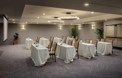 a room with tables and chairs with white table cloths at Toll House Hotel Los Gatos in Los Gatos