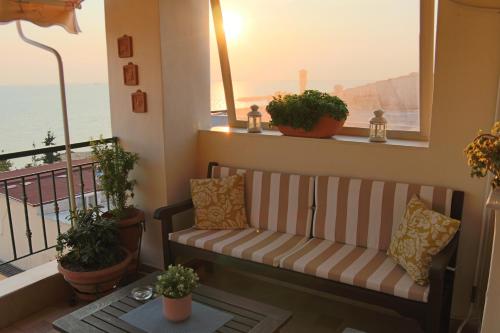 a couch on a balcony with a view of the ocean at Apartment with marina view in Thessaloniki