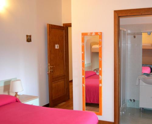 a room with a bed and a mirror and a bedroom at Country House Bucaneve in Rovolon