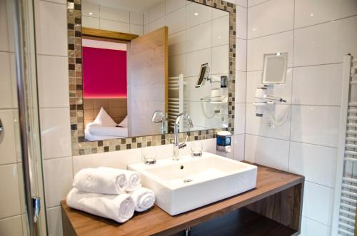 a bathroom with a sink and a mirror at Hotel Garni Alpenland in Ischgl