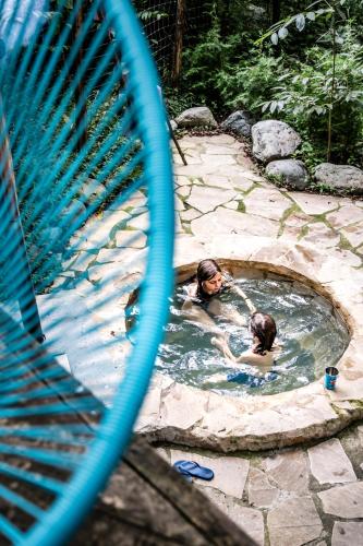a man and a woman in a swimming pool at Duende Hotel in Lagodekhi