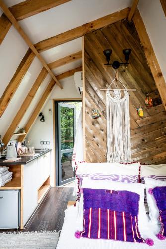 a bedroom with a bed and a wooden ceiling at Duende Hotel in Lagodekhi