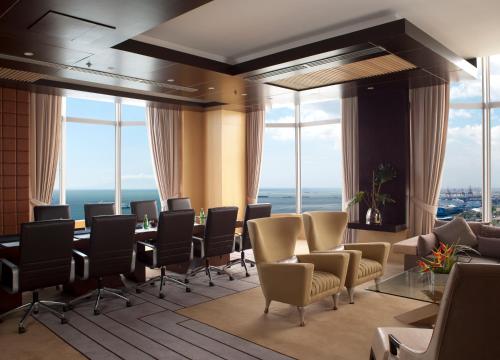 a conference room with chairs and tables and windows at Diamond Hotel Philippines in Manila