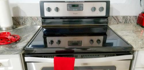 a stove in a kitchen with a red towel on it at Casa Tamar Guest Apartment in Kingston