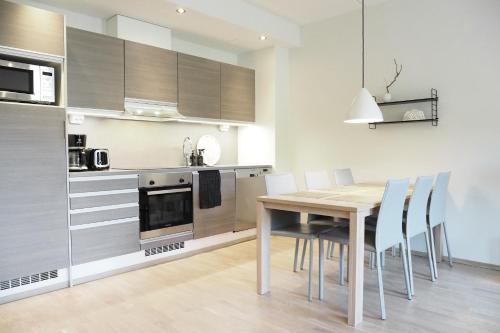 a kitchen and dining room with a table and chairs at RUKA2103 CHALET in Kuusamo