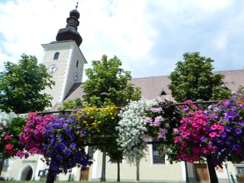 a church with a bunch of flowers in front of it at Wohlfühl - Appartement Fewo Pichlarn Irdning Ferienwohnung in Aigen im Ennstal
