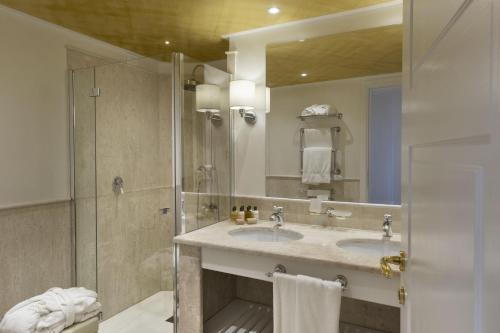 a bathroom with a sink, toilet and shower at Hotel Abi d'Oru in Porto Rotondo