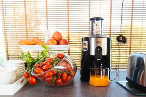 a kitchen counter with a blender and a bowl of tomatoes at Le Monachelle Luxury in Eboli