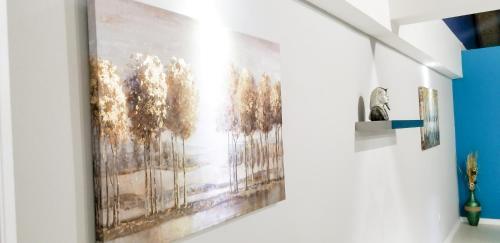 a painting hanging on a wall in a room at Casa Tamar Guest Apartment in Kingston