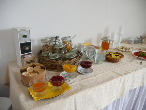 a table with food and jars and baskets on it at Bleckmanns Hof in Werne an der Lippe