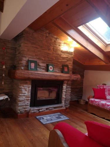 a living room with a stone fireplace in a house at Mansarda Belvedere in Scopello