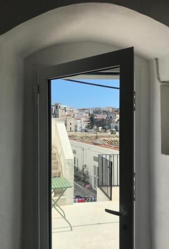 an open door with a view of a city at Fico d’India apartments in Monte SantʼAngelo
