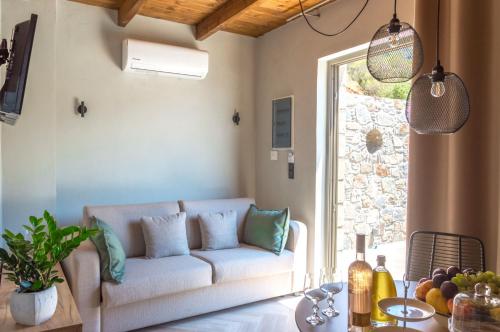 a living room with a couch and a table at INO I, sea goddess domus by Amigdalokefali Elafonissi in Kissamos