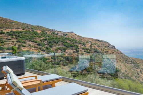 a balcony with a view of a mountain at INO I, sea goddess domus jacuzzi by Amigdalokefali Elafonissi in Kissamos