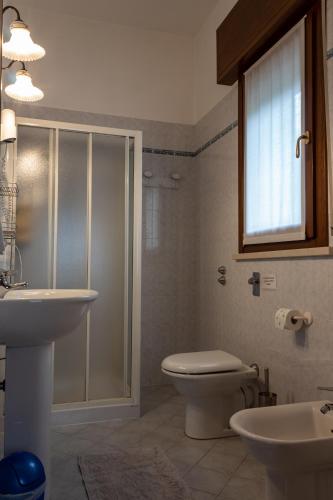 a bathroom with a toilet and a sink and a shower at Agriturismo Cà Rossa in Pegognaga