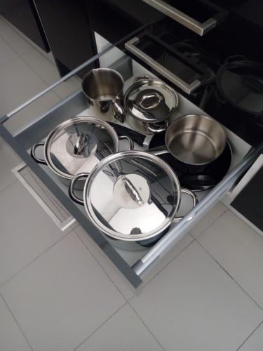 a bunch of pots and pans on a shelf in a kitchen at Casa do Rio - Penacova in Raiva