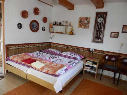 a bedroom with a bed and a table and a chair at Penzión Bajo in Dolný Kubín