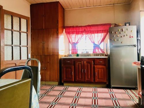 a kitchen with a refrigerator and a window at Casa Afif in Tlatlauquitepec