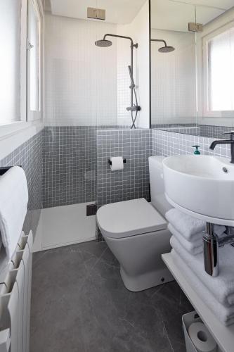 a bathroom with a white toilet and a sink at ATeRIAN MUSKARIA in Zarautz