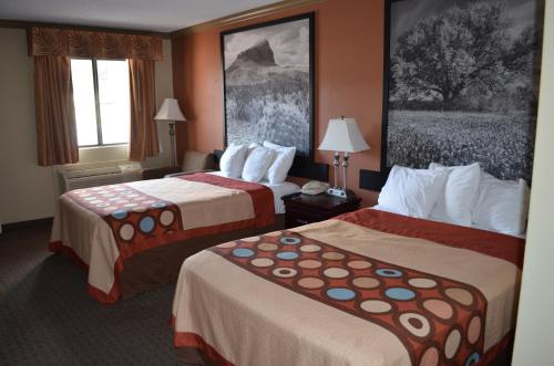 a hotel room with two beds and a window at Hill Country Inn and Suite in Copperas Cove