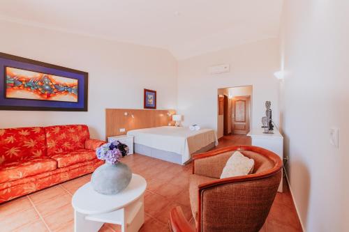 a living room with a bed and a couch at Villa Amore Accommodation by Amazing Madeira in Paul do Mar
