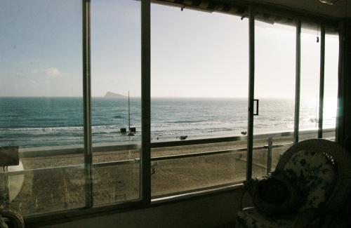 a room with a view of the ocean from a window at Apartamentos Carolina - Arca Rent in Benidorm