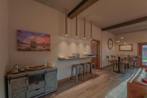 a kitchen and living room with a table and chairs at Golden Stone Inn in West Yellowstone