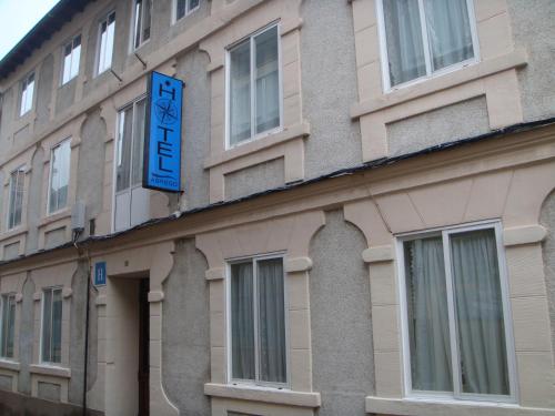 un edificio con una señal azul en el costado. en Hotel Abrego Reinosa, en Reinosa