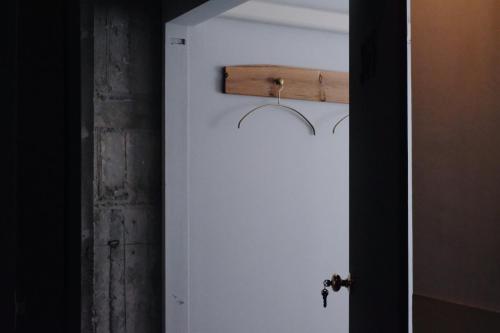 a white door with a wooden handle on it at Beppu hostel&cafe ourschestra - Vacation STAY 45859 in Beppu