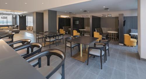 a restaurant with tables and chairs in a room at Residence Inn by Marriott Halifax Dartmouth in Halifax