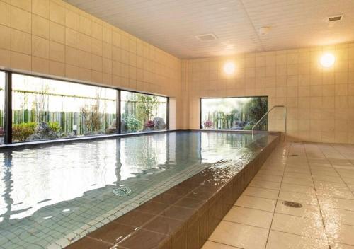 - une grande piscine dans un bâtiment doté de fenêtres dans l'établissement Higashimatsushima - Hotel / Vacation STAY 43089, à Higashimatsushima