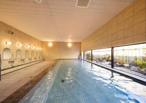a large swimming pool in a building with a swimming pool at Higashimatsushima - Hotel / Vacation STAY 43094 in Higashimatsushima