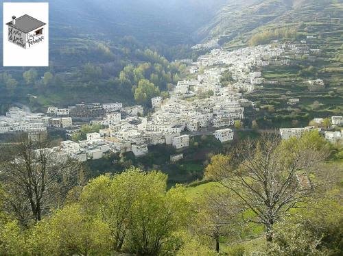 a view of a city from a hill with trees at Hostal Casa Fermina- A 2 horas de las pistas de esquí in Trevélez