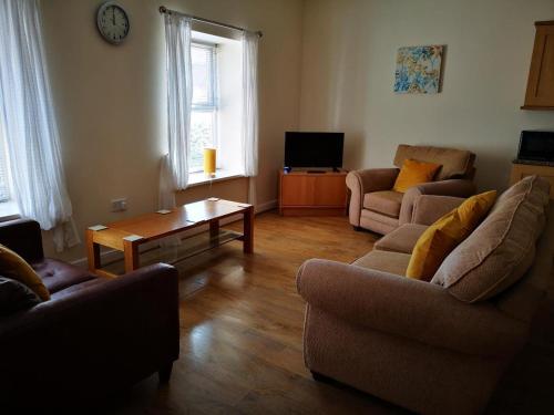 a living room with two couches and a coffee table at Contemporary Cottage Holidays in Bridlington