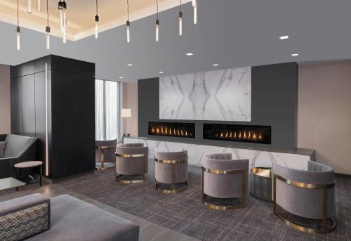 a lobby with a bar with stools and a fireplace at Residence Inn by Marriott Halifax Dartmouth in Halifax