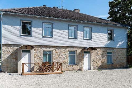 a stone house with a wooden table in front of it at Mia Guesthouse in Haljala