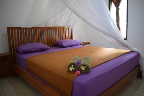 a bed with two towels and two pillows on it at Safsia homestay in Nusa Penida