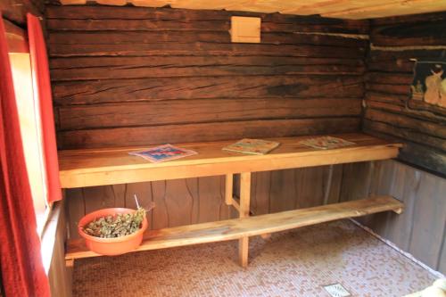 a wooden table and a bench in a room at Männi Summerhouse in Kassari