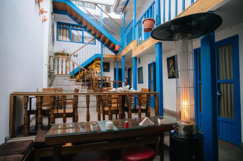 a restaurant with tables and chairs and a staircase at La Casa de Mayte in Cusco