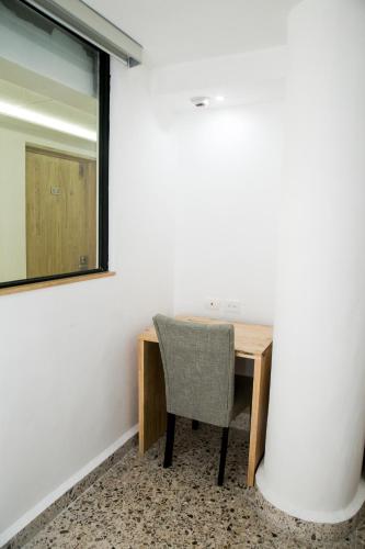 a desk and chair in a room with a mirror at Booking 500 in Monterrey