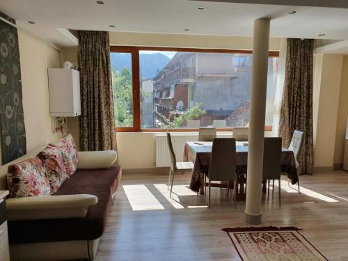 a living room with a couch and a dining room table at Montana View in Poiana Brasov
